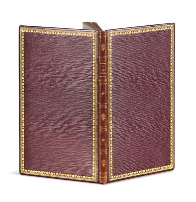 an old book with a leather cover on a white background