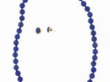 a blue beaded necklace and earring set with a gold clasp