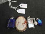 a necklace with a picture of a woman on it next to other items