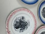 many plates with different designs on them on a table