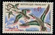 a stamp with a picture of two ducks flying in the sky
