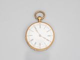 a gold pocket watch with roman numerals on the face