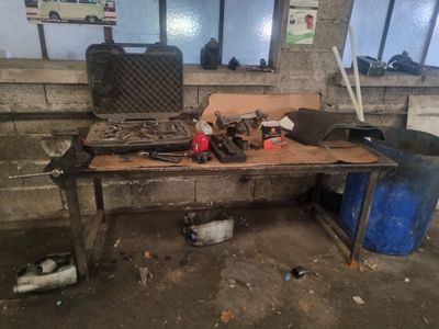 a workbench with tools on top of it in a building