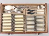 a wooden box with silverware in it on a table
