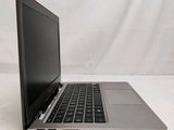 a laptop that is sitting on a white surface
