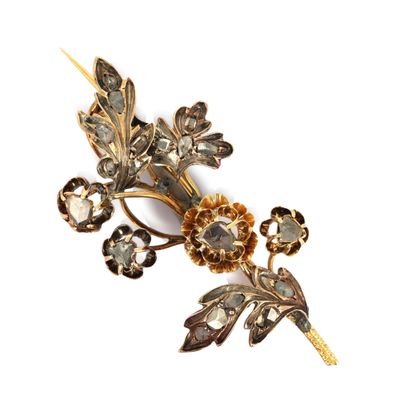 une image représentant une broche ornée de fleurs et de feuilles sur fond blanc