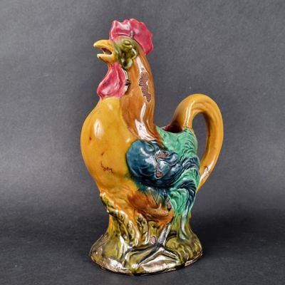 a ceramic rooster that is sitting on a table