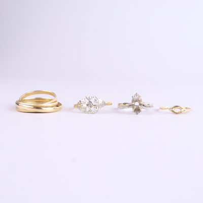 three gold rings and two silver rings on a white background