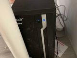 a black computer sitting on top of a wooden desk