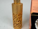 a small bottle of perfume sitting next to a box