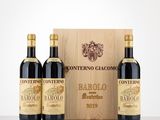 three bottles of wine in front of a wooden box