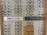 many pairs of glasses on display in a display case