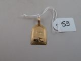 a gold pendant with a picture of a woman on it