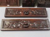 three pieces of carved wood are sitting next to each other