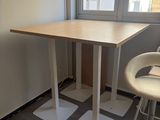 a small table and two chairs in the corner of a room