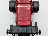 a red toy truck that is sitting on a white surface
