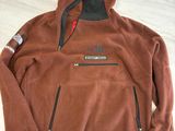 a close up of a brown flee jacket on a table