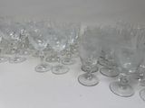 many empty wine glasses lined up on the table