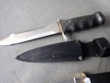 two knives that are laying next to each other on a table