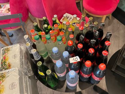 many bottles of soda and water on the table
