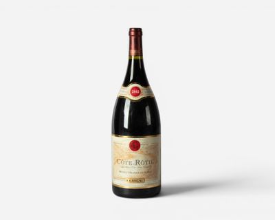 a bottle of wine sitting on top of a white surface