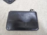 a black leather wallet with a keychain attached to it