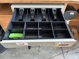 a drawer with utensils and other items in it