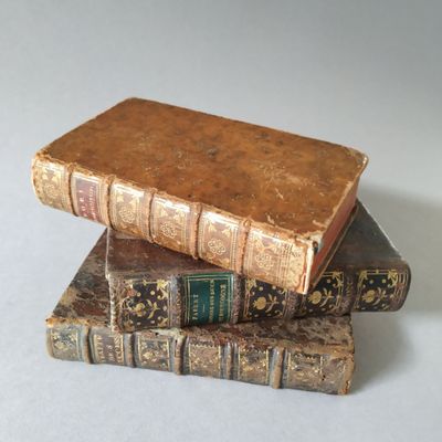 three books stacked on top of each other on a table