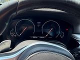 steering wheel of a bmw car with gauges and speedometers