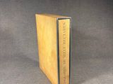 a book that is sitting on a table with a black background