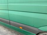 a green van that is parked on the side of the road