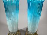 pair of blue glass vases with gold bases on a white background