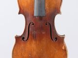 an old violin with a bow hanging from it ' s back