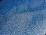 a close up of a blue couch with a blue cover on it