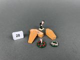 miniature figurines of a man on a wooden ramp with a christmas wreath