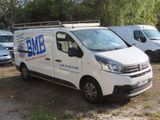 a white van that is parked next to other vans