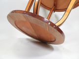 a wooden chair that has a wooden seat on it