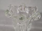 a clear glass vase with a decorative design on it