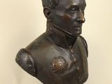 an antique bronze bust of a man wearing a military uniform
