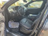 the interior of a car with the door open showing the dashboard