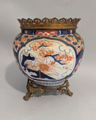 un vase orné d'une bordure dorée et d'un motif bleu et orange