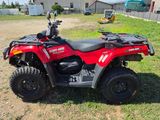 an image of a red four wheeler atv parked in a field