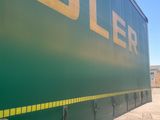 a large green truck that is parked on the side of the road