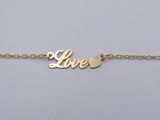 a gold plated bracelet with the word love written on it
