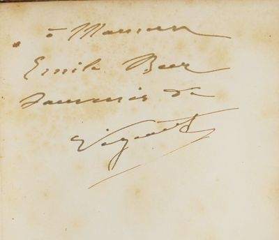 an old book with writing on it sitting on top of a table