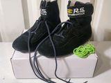 a pair of black shoes sitting on top of a box