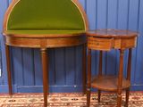 a small table with a green cushion on it and a small table with a green cushion on it