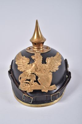 an image of a black and gold helmet with a golden eagle on it
