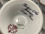a person holding a cup that has a quote on it