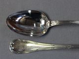 two spoons that are sitting on a table